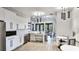 Modern kitchen area featuring white cabinetry, stainless steel appliances, and stylish pendant lighting at 5927 Maidenstone Way, Palmetto, FL 34221
