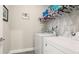 Well-equipped laundry room with washer, dryer, and overhead storage for convenient organization at 5927 Maidenstone Way, Palmetto, FL 34221