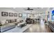 Open-concept living room with hardwood flooring flowing into the kitchen and adjacent breakfast nook at 5927 Maidenstone Way, Palmetto, FL 34221