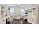 Spacious home office featuring two built-in desks and shelving units perfect for productivity and organization at 5927 Maidenstone Way, Palmetto, FL 34221