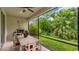 Relaxing screened patio with dining set provides an outdoor living area surrounded by lush greenery at 5927 Maidenstone Way, Palmetto, FL 34221