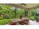Relaxing screened patio with dining set provides an outdoor living area surrounded by lush greenery at 5927 Maidenstone Way, Palmetto, FL 34221