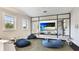 Inviting playroom with beanbag chairs, play tables, and a large screen, perfect for ' entertainment at 5927 Maidenstone Way, Palmetto, FL 34221