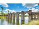 Serene water feature with a stone bridge and fountain, enhancing the community's beauty at 5927 Maidenstone Way, Palmetto, FL 34221