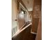 Well-lit hallway with hardwood floors and stylish decor, connecting different areas of the home at 6048 Merril St, North Port, FL 34287