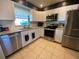 Modern kitchen with stainless steel appliances, granite countertops, and ample cabinet space at 6048 Merril St, North Port, FL 34287