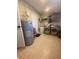 Functional laundry room with washer, dryer, sink and water heater on tile floor at 6048 Merril St, North Port, FL 34287