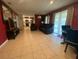 Open-concept living room with tile flooring, a dining area, and access to the kitchen at 6048 Merril St, North Port, FL 34287