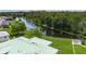 Backyard view featuring a serene lake, lush greenery, and the home's green roof at 6114 68Th E Dr, Palmetto, FL 34221