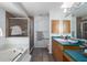 Bathroom featuring a tub, walk-in shower, and vanity with ample counter space at 6114 68Th E Dr, Palmetto, FL 34221