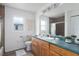 Clean bathroom with wooden vanity and shower with brown tile at 6114 68Th E Dr, Palmetto, FL 34221