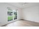 Neutral bedroom features a large window overlooking a landscaped front yard at 6114 68Th E Dr, Palmetto, FL 34221