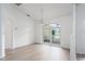 Bright, minimalist dining area with hardwood floors, large window, and a chandelier at 6114 68Th E Dr, Palmetto, FL 34221