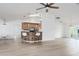Open-concept space with a kitchen bar, hardwood floors, fan, and lots of sunlight at 6114 68Th E Dr, Palmetto, FL 34221