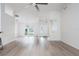 Bright living room with new hardwood flooring, chandelier, and an inviting open layout at 6114 68Th E Dr, Palmetto, FL 34221