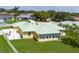 Aerial view of the back of a home with green metal roof, patio, and fenced yard, highlighting the outdoor space at 6114 68Th E Dr, Palmetto, FL 34221