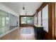 Bright sunroom with wood paneling, wood-look floors, and a sliding glass door at 6114 68Th E Dr, Palmetto, FL 34221