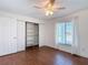 Bright bedroom features wood-look flooring, a window, and closet with built in shelving at 6341 Cocoa Ln, Apollo Beach, FL 33572