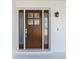 Beautiful front door with sidelights and glass panes with white trim at 6341 Cocoa Ln, Apollo Beach, FL 33572
