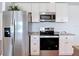 Updated kitchen with stainless steel appliances and ample cabinet space at 6341 Cocoa Ln, Apollo Beach, FL 33572