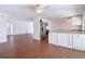 Open-concept kitchen featuring stainless steel appliances, white cabinetry and wood-look flooring at 6341 Cocoa Ln, Apollo Beach, FL 33572