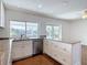 Kitchen with stainless steel appliances, white cabinetry, and granite countertops overlooking waterfront at 6341 Cocoa Ln, Apollo Beach, FL 33572