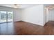 Bright living room with access to the canal through sliding glass doors and wood-look flooring at 6341 Cocoa Ln, Apollo Beach, FL 33572