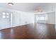 Bright living room featuring wood-look floors, a ceiling fan, and natural light at 6341 Cocoa Ln, Apollo Beach, FL 33572
