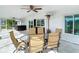 Enclosed patio featuring an outdoor seating area, ceiling fans, wet bar, and hot tub at 6341 Cocoa Ln, Apollo Beach, FL 33572