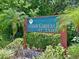 Fairway Gardens II at Tara community sign surrounded by lush greenery and a small palm tree at 6821 Fairview Ter # 6821, Bradenton, FL 34203