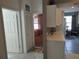 Bright hallway featuring tile floors, bedroom access, and a glimpse into an open-concept living space at 6821 Fairview Ter # 6821, Bradenton, FL 34203