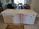 Kitchen island features a sink, a dishwasher, white cabinetry and seating at 6821 Fairview Ter # 6821, Bradenton, FL 34203