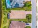 Aerial view of home showing paved driveway, solar panels, screened patio and water view at 6854 Chester Trl, Lakewood Ranch, FL 34202