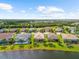 Aerial view of home with lush backyard overlooking the lake in a well-maintained community at 6854 Chester Trl, Lakewood Ranch, FL 34202