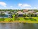 Aerial view of lakefront property with screened in lanai and well-manicured backyard and landscaping at 6854 Chester Trl, Lakewood Ranch, FL 34202