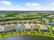 Aerial view of home with lush landscaping, screened in patio, and peaceful lake views at 6854 Chester Trl, Lakewood Ranch, FL 34202