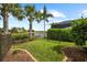 Well-maintained backyard with lush lawn, elegant landscaping, and scenic water views at 6854 Chester Trl, Lakewood Ranch, FL 34202