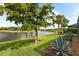 Lush backyard with manicured lawn leading to a serene lake view at 6854 Chester Trl, Lakewood Ranch, FL 34202