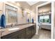 Bathroom showcasing granite countertops, dual sinks, and a doorway that offers a glimpse into the bedroom at 6854 Chester Trl, Lakewood Ranch, FL 34202