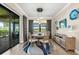 The dining area features modern lighting, stylish decor, and sliding glass doors to the outdoor lanai at 6854 Chester Trl, Lakewood Ranch, FL 34202