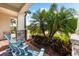 Inviting front porch with two chairs, stone columns, and lush landscaping at 6854 Chester Trl, Lakewood Ranch, FL 34202