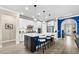 Bright kitchen with island seating, stainless appliances, and a sleek design leading to the living area at 6854 Chester Trl, Lakewood Ranch, FL 34202
