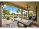 Spacious lanai with brick flooring, a dining table, and a view of the pond and tropical landscaping at 6854 Chester Trl, Lakewood Ranch, FL 34202