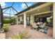 Lanai with brick flooring, ceiling fans, and both dining and seating areas, perfect for outdoor relaxation at 6854 Chester Trl, Lakewood Ranch, FL 34202