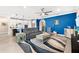 Comfortable living room leading to a kitchen, featuring stylish decor and a modern ceiling fan at 6854 Chester Trl, Lakewood Ranch, FL 34202