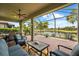 Relaxing screened-in patio featuring comfortable seating with a serene lake view at 6854 Chester Trl, Lakewood Ranch, FL 34202