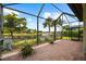 Large screened lanai with beautiful lake view, brick flooring, and tropical landscaping at 6854 Chester Trl, Lakewood Ranch, FL 34202