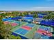 Aerial view of community pickleball courts, with multiple courts and active players at 6854 Chester Trl, Lakewood Ranch, FL 34202