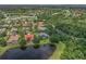 Aerial view showcases the community's proximity to a golf course and neighborhood lakes at 6959 Westchester Cir, Bradenton, FL 34202