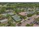 Aerial view of the community's extensive tennis facilities with meticulously maintained courts and clubhouse at 6959 Westchester Cir, Bradenton, FL 34202